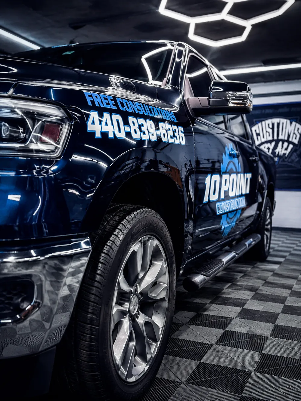 Black RAM 1500 truck with a custom commercial wrap for 10 Point Construction by CustomsByAli in Elyria, OH